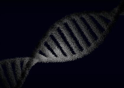 Artistic rendering of a DNA strand with particle effects against a dark background.