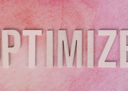 Creative display of the word 'OPTIMIZE' on a pink textured surface.