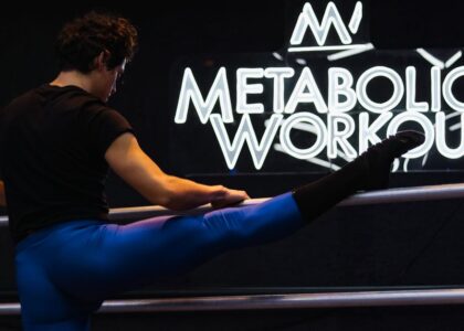 Athlete performing a leg stretch at Metabolic Workout studio in Mexico City.
